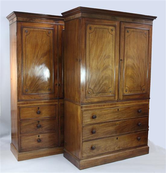A matched pair of Regency style ebony strung mahogany wardrobes, W.4ft 4in. D.1ft 10in. H.7ft